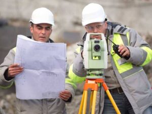 Due diligence survey in Mesquite Texas with land surveyors reviewing property plans and using surveying equipment.